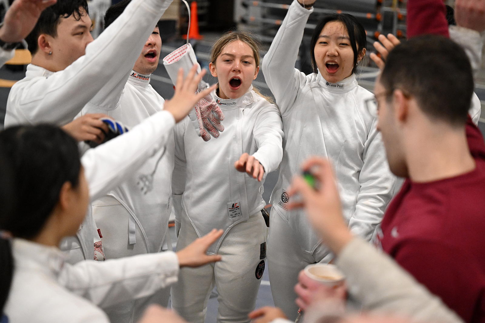 Members of the fencing team in a circle