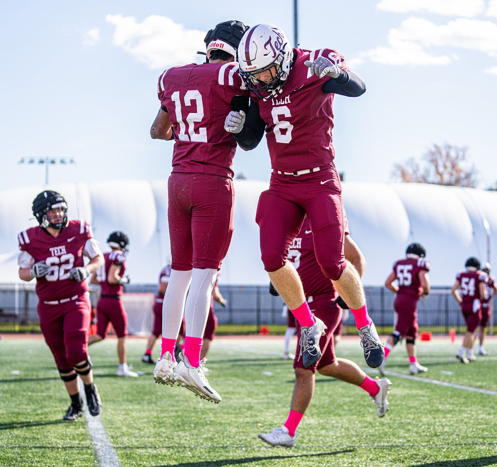 MIT football players jumping