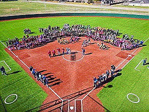 A group of people on a baseball fieldAI-generated content may be incorrect.