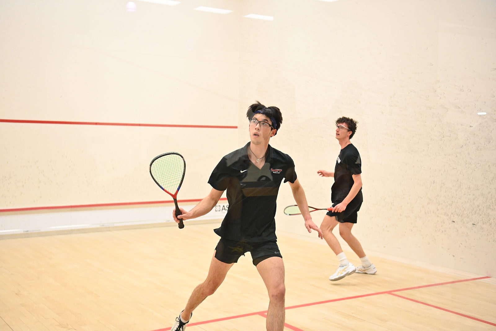 Squash player mid-swing 