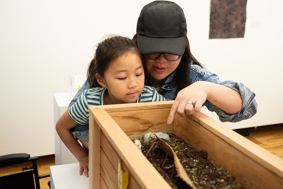 Jerome Residency artist, Leah Willemin shows her work to guests at the 2022 Jerome Book Arts Residency opening reception.
