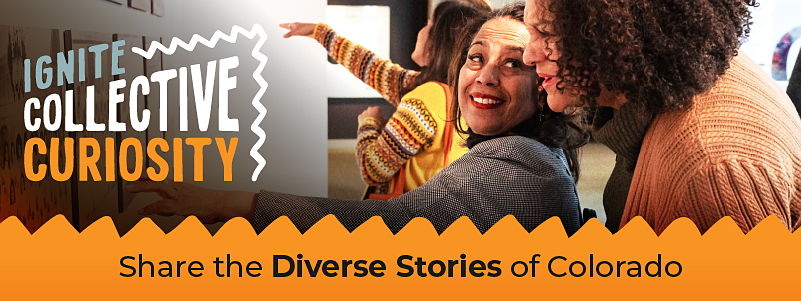 Two women talking about a museum exhibition piece, while a woman admires another piece as she points to it, representing sharing diverse stories
