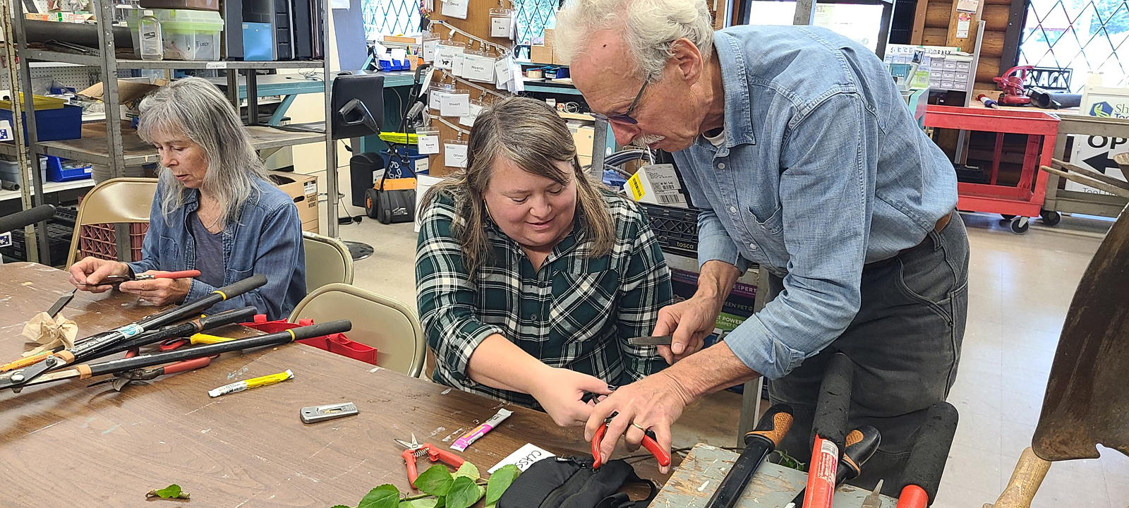 Members learning how to sharpen tools
