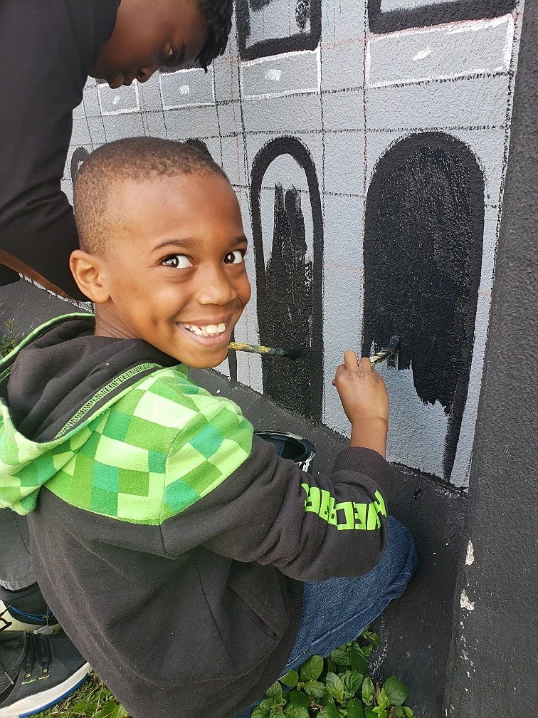 A child painting a wall AI-generated content may be incorrect.