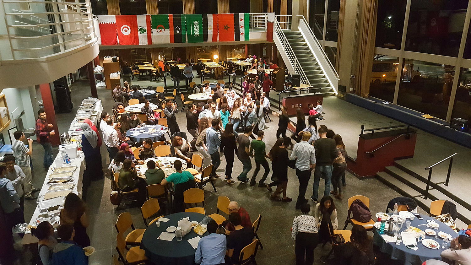 A birds-eye view of an ASO party, where people are sitting, eating, and dancing