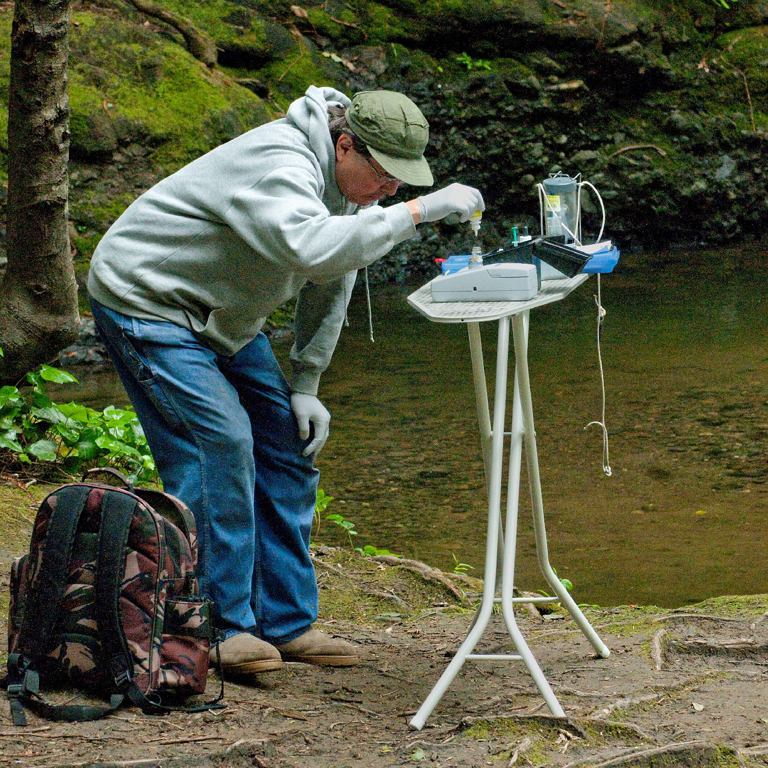 A volunteer performs water quality tests at a site on La Honda Creek.