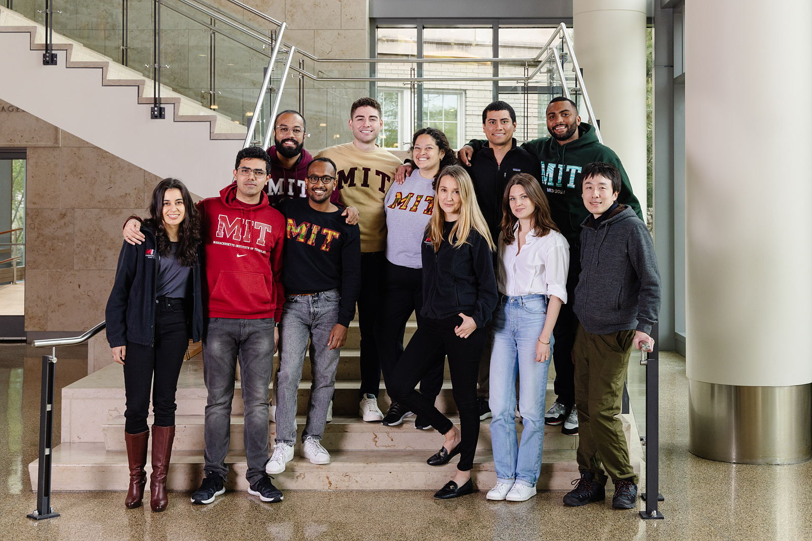 Sloan student stand together on stairs