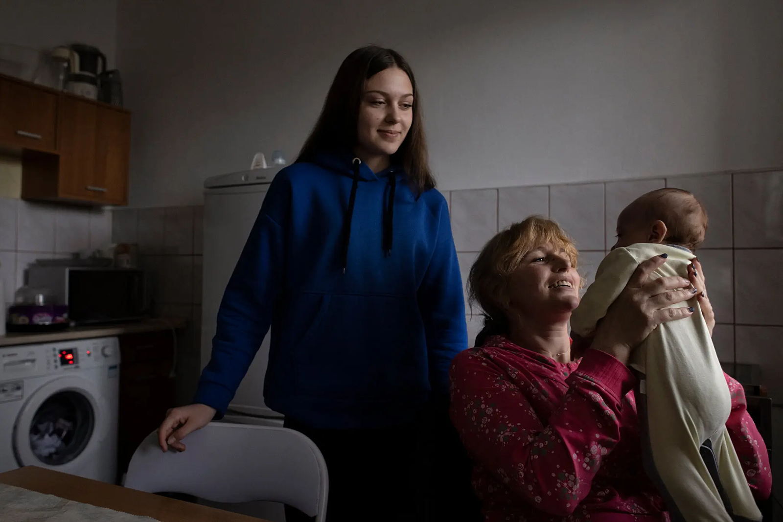 Lyubomira Pancuk, middle, with her daughter Andriana, 15, and her month-old son, Danilo, in Zabki, Poland. The family fled to Poland from Eastern Ukraine.Credit...Maciek Nabrdalik for The New York Times