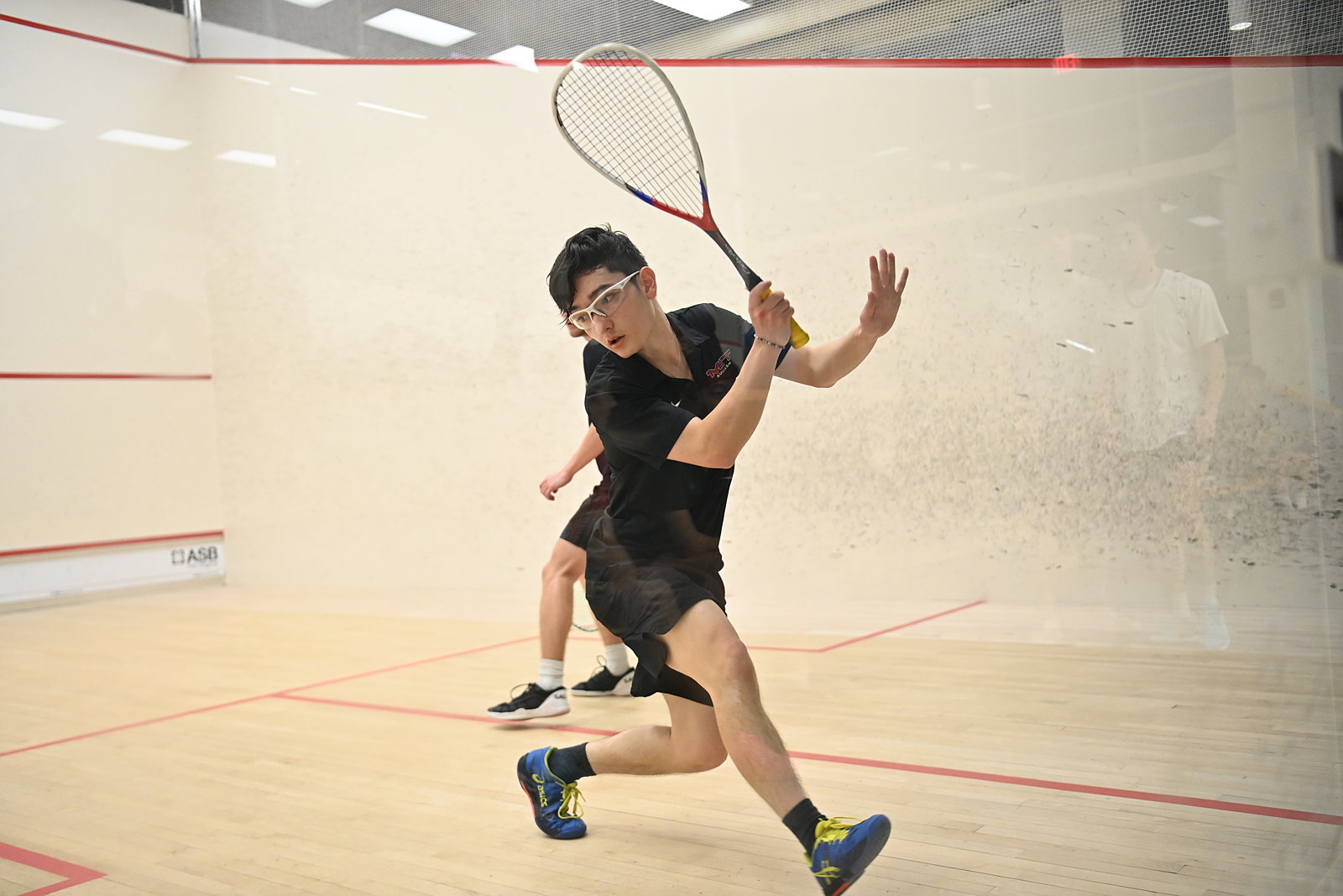 Squash player mid-swing 