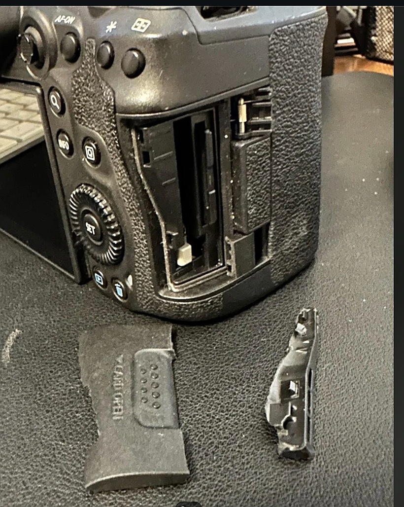 A Canon EOS 5D Mark IV camera with a cracked and broken side