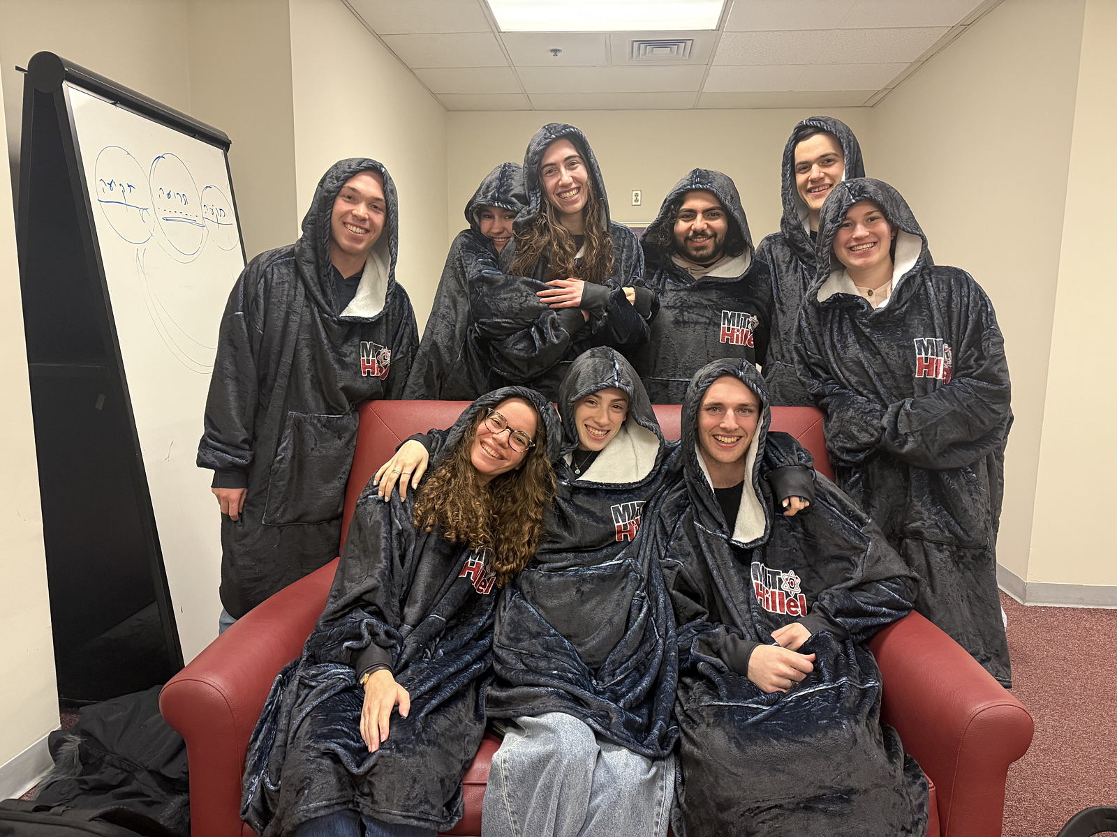 A group photo in Hillel branded hooded blankets