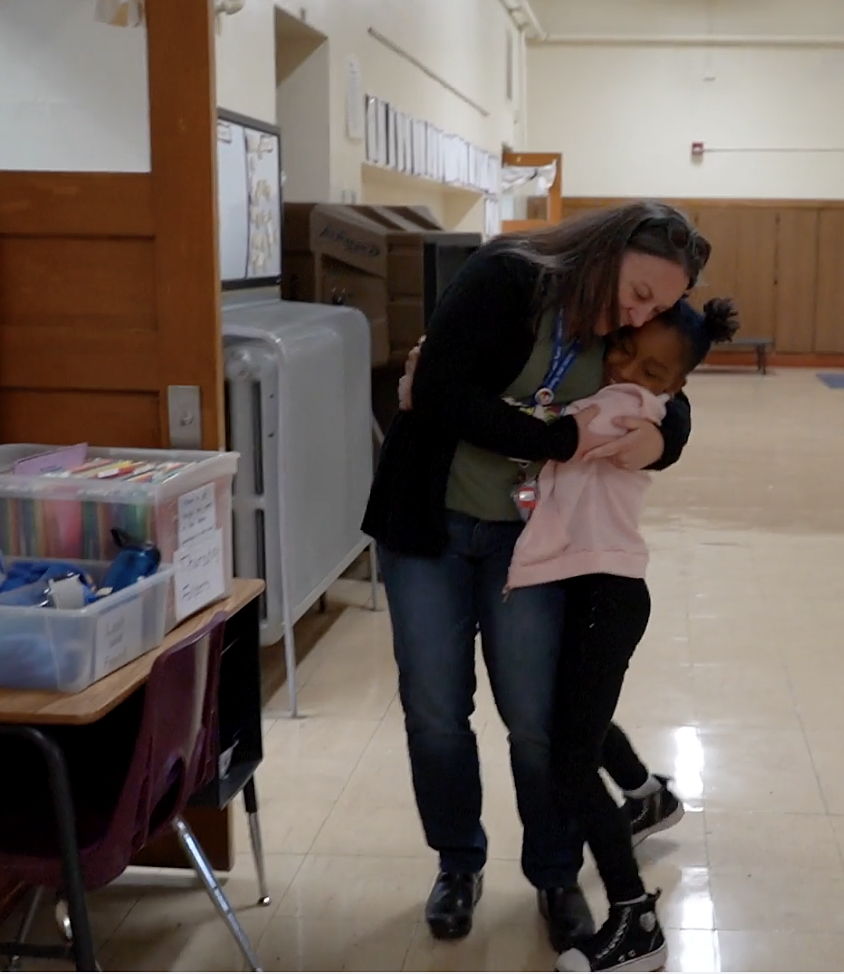 Social worked Kelly Dulong hugging a Polaris student