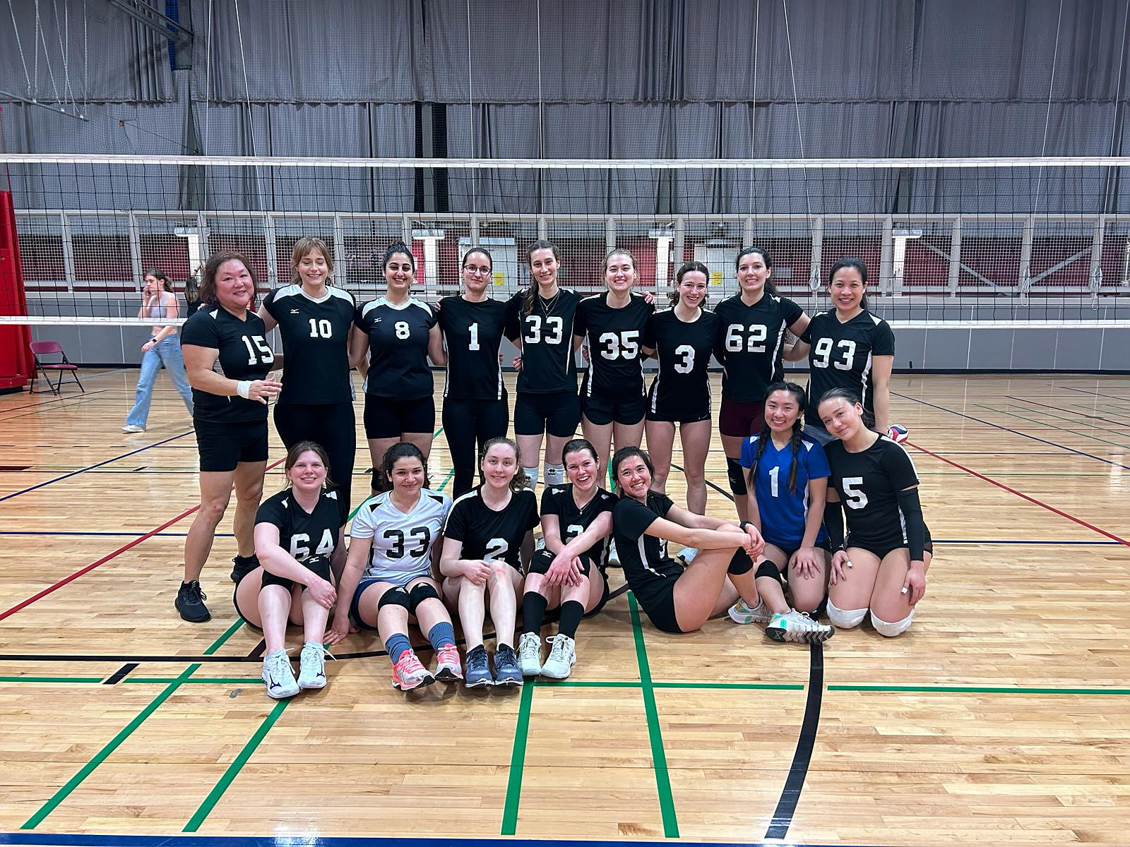 Women's club volleyball team poses for a picture