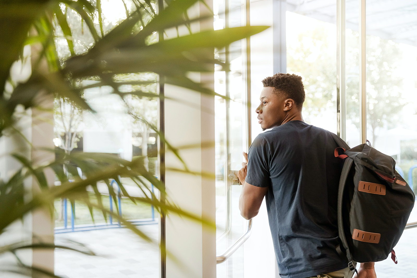 Student pushing open door.