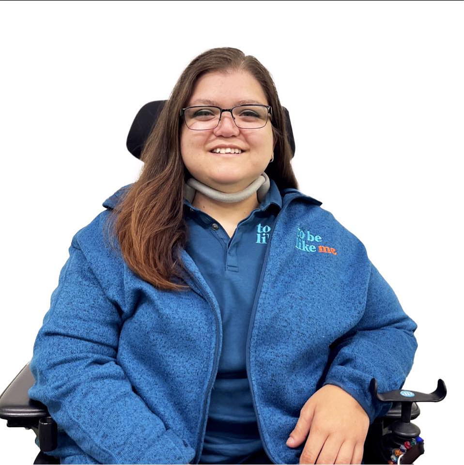 Shawnett on a white background, wearing her TBLM polo shirt and fleece.
