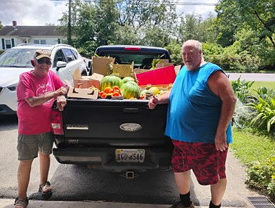 Members of the Giles Community Garden pack a truck bed with produce