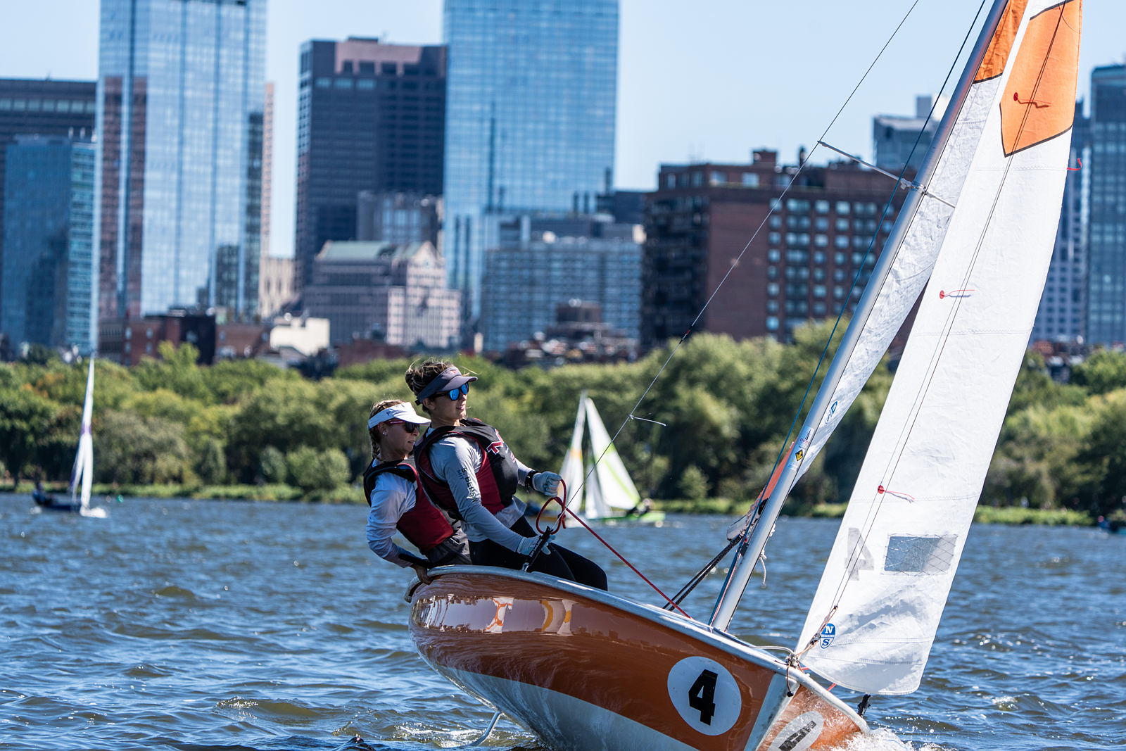 Two sailors steering a boat
