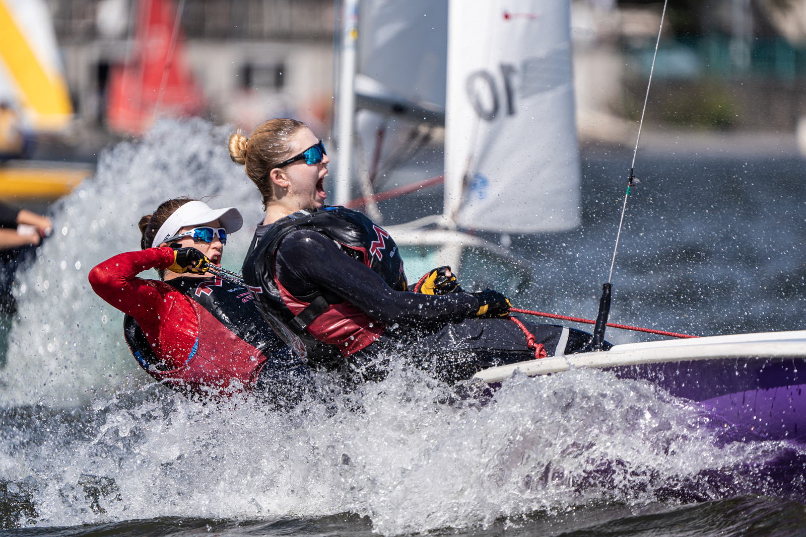Two sailors steering a boat