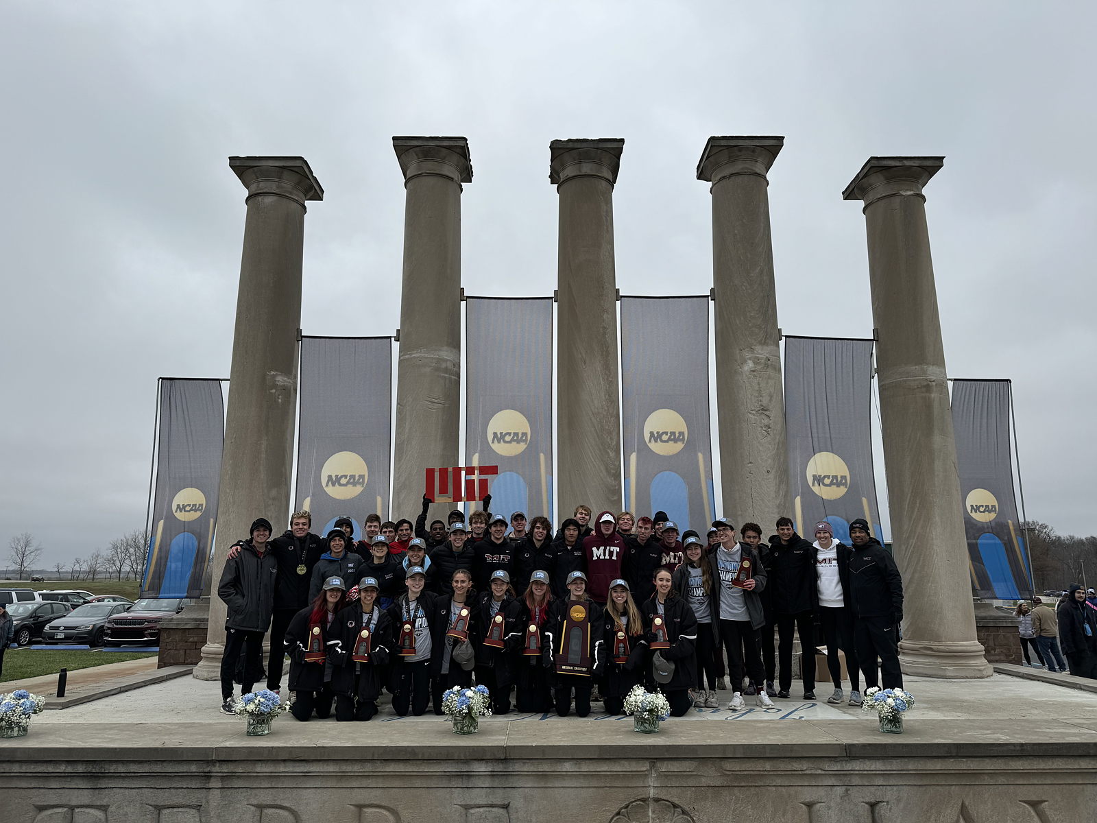Cross Country Team poses with trophies