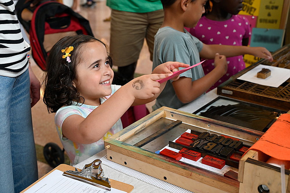 Jerome Residency artist, Leah Willemin shows her work to guests at the 2022 Jerome Book Arts Residency opening reception.