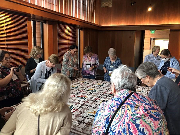 A group of people around a table AI-generated content may be incorrect.