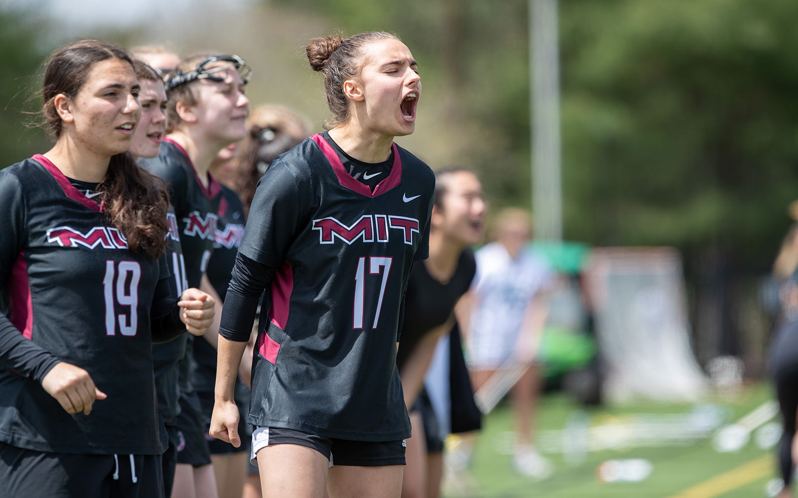 Women's Lacrosse team member enthusiastically cheers