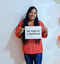 A person holding a sign

Description automatically generated