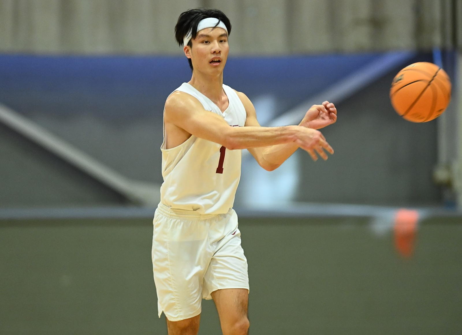 Men's basketball team member throws ball