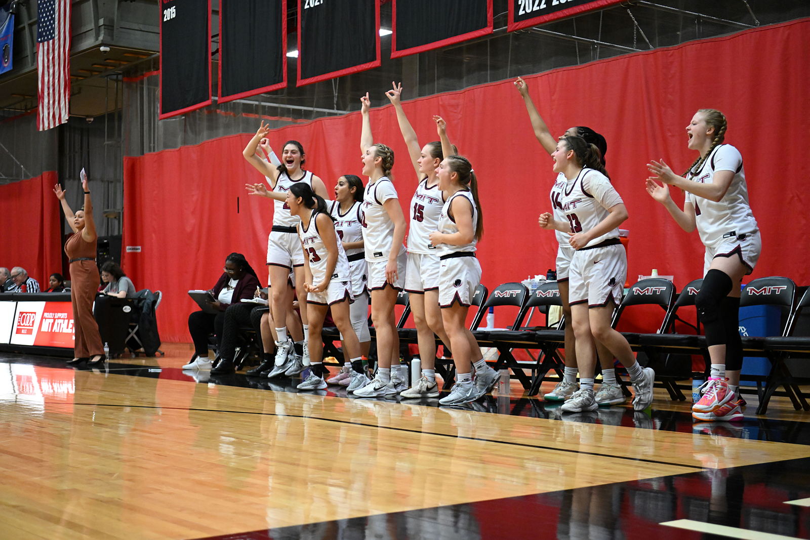 Women's Basketball team members cheer courtside