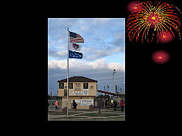 A flagpole with flags flying in the windAI-generated content may be incorrect.