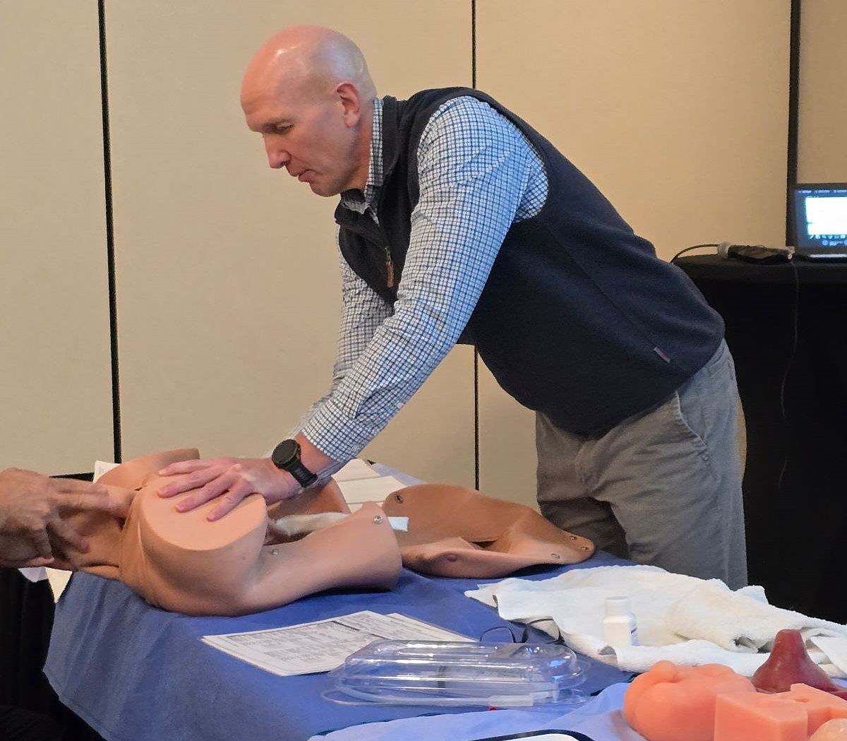 Image shows an instructor using an Obstetrics Manikin to demonstrate the birthing process.