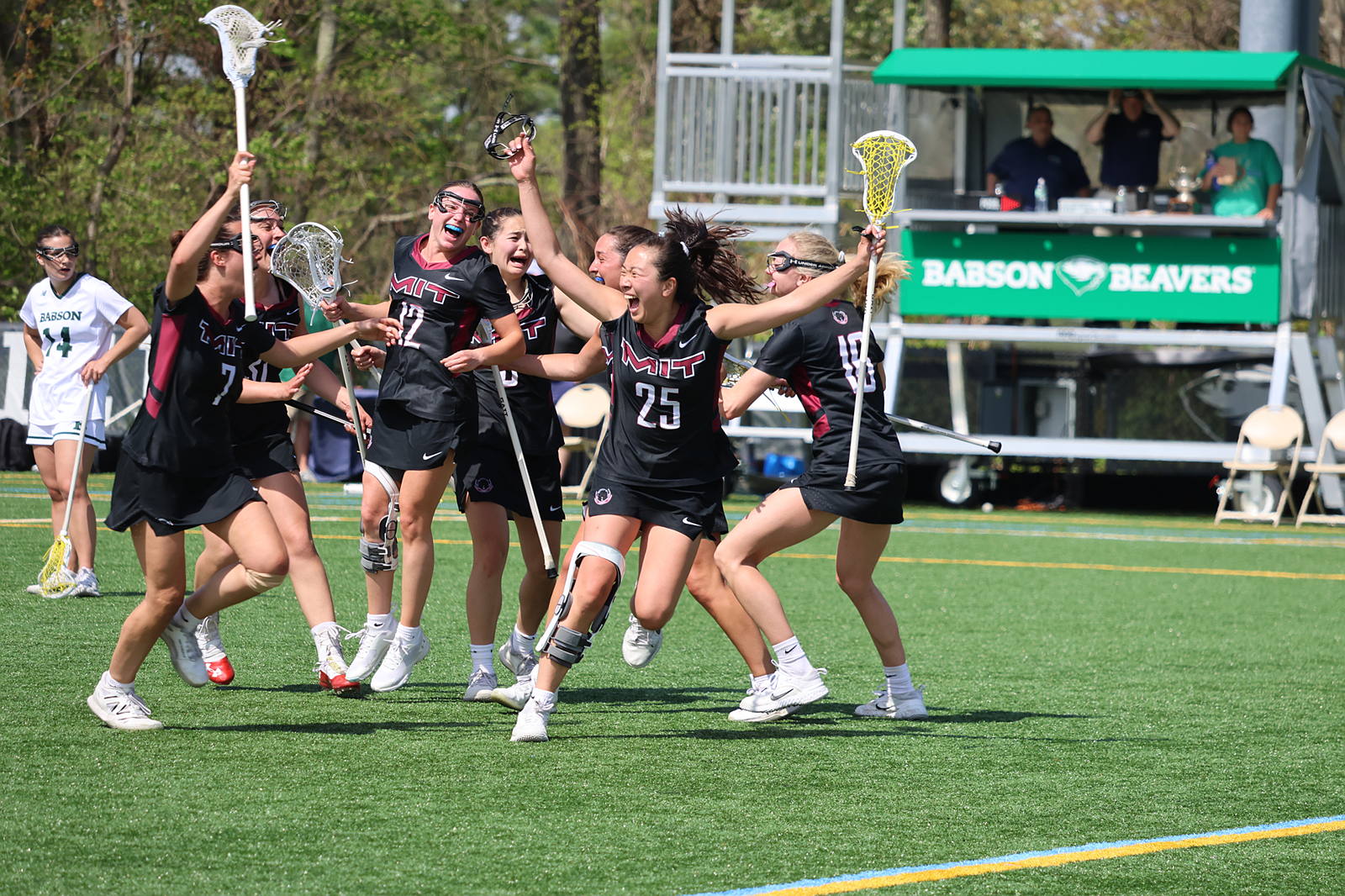 Women's Lacrosse team members enthusiastically cheer on field