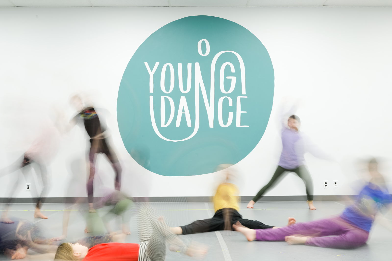 Blurry Group of Dancers next to the Young Dance logo