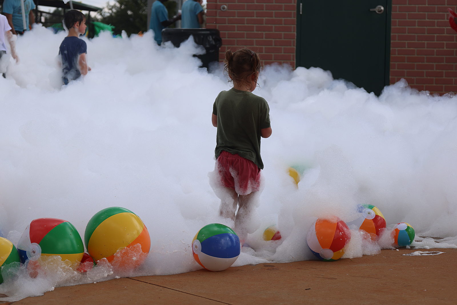 A child running through foam at KidStuff-USA Family Fun Day